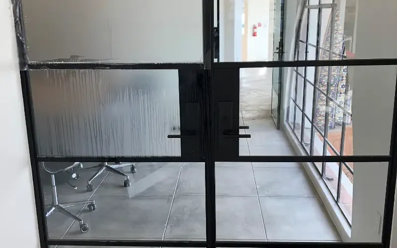 A privacy film panel going up wet on an interior glass door.