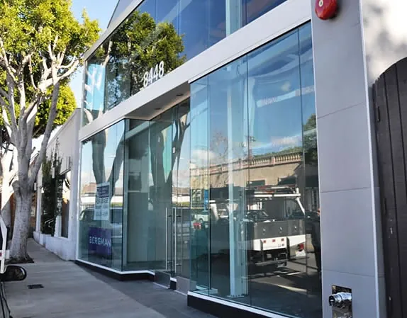 A glass commercial entrance carrying safety film across every pane.