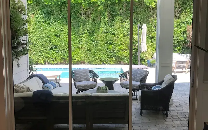 Full-height patio doors carrying clear film that holds the glass together on impact.